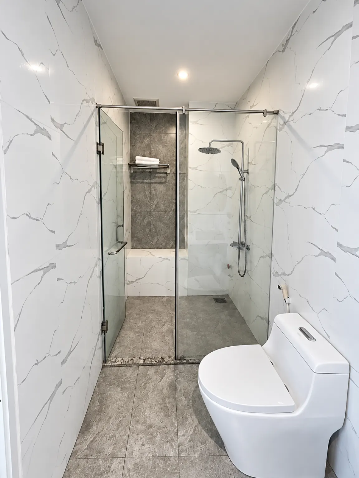 Private bathroom with a glass-enclosed walk-in shower