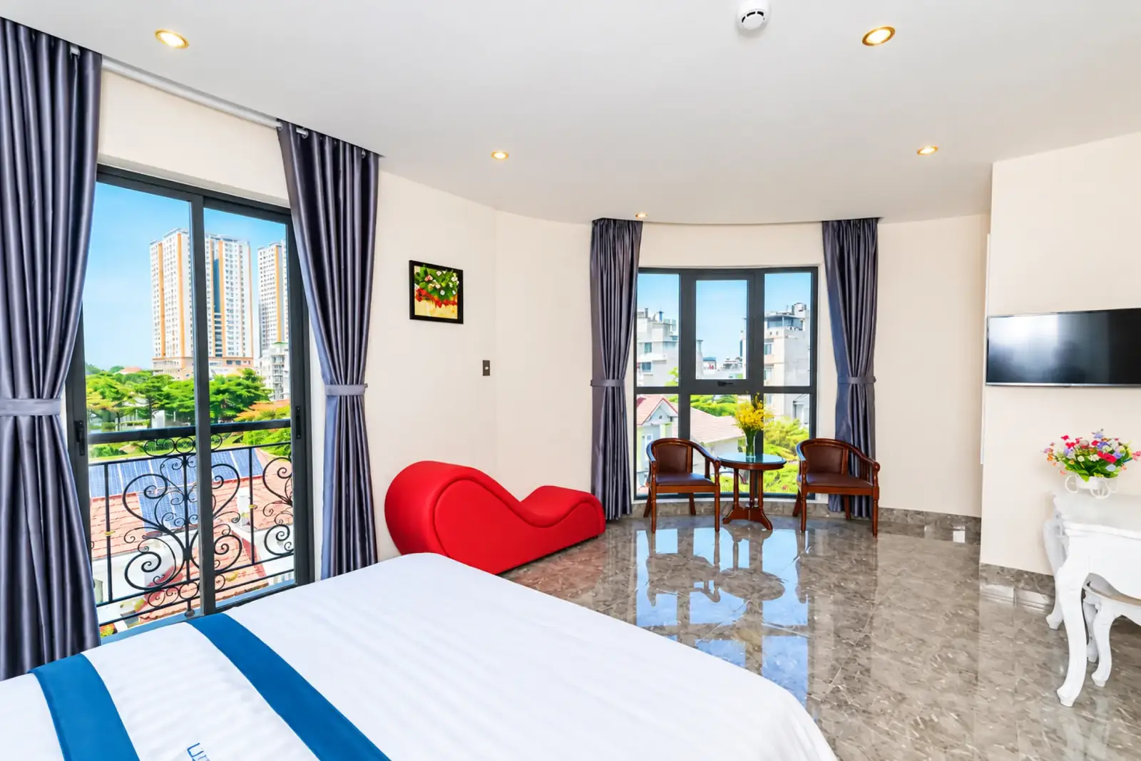 Spacious Sun Beach Hotel suite with wide windows and seating